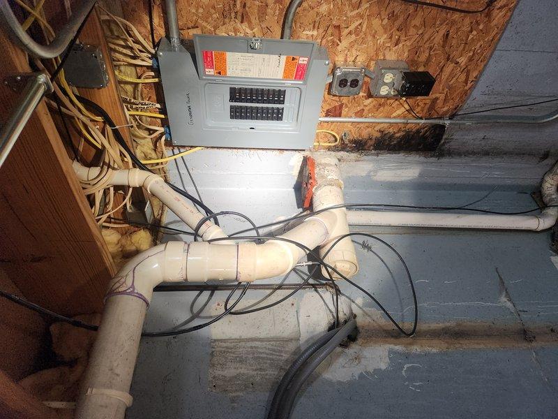 Responded to service call regarding sewer gas odor emanating from drainage system. Upon inspection of the utility area, identified a floor drain assembly with an improperly functioning or damaged trap primer device that was allowing sewer gases to escape into the building. The device in question appeared to be connected to the main drain line where it exits the building foundation. Documented existing conditions with photographs showing the drain configuration, PVC piping layout, and the suspected gas leak source. Advised customer on options for remediation, including potential replacement of the trap primer assembly or elimination of the device if not required by current plumbing code. Recommended follow-up evaluation to determine the most appropriate solution based on local code requirements and building usage.