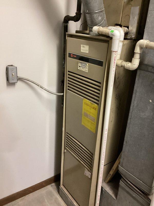 Responded to no-cooling call on residential HVAC system approximately 10 years old. Upon arrival, confirmed system was clicking but failing to start with no airflow through vents and no tripped breakers. Performed diagnostic evaluation of electrical components at disconnect switch and main panel, inspected furnace unit and associated condensate lines, and examined all visible electrical connections and control circuits to identify failure point preventing compressor and blower operation.