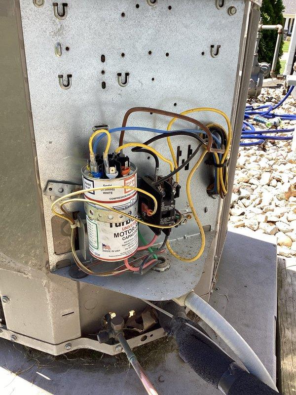 Completed comprehensive cooling season tune-up on 9-year-old residential air conditioning system. Performed visual inspection of outdoor condenser unit, noting significant accumulation of dirt, dust, and debris on condenser coils and protective wire guard. Opened electrical control panel and inspected internal components including dual-run capacitor, contactor relay, and associated wiring connections for proper operation and signs of wear. Cleaned condenser coils and removed organic debris from unit exterior to restore optimal airflow and heat transfer efficiency. Verified system operational status and confirmed unit cycling properly with no performance issues reported by customer.
