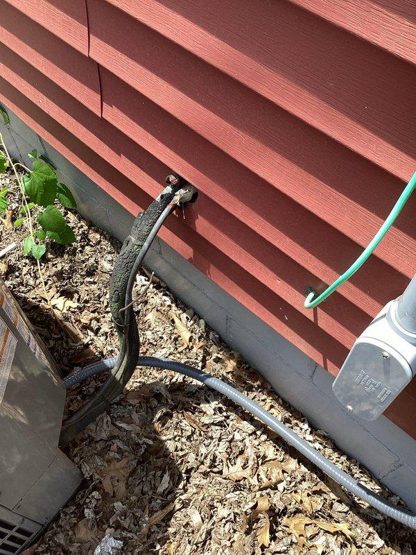 Responded to callback regarding non-functional air conditioning system that was not included in original restoration scope. Upon inspection, discovered existing lineset in basement was severely deteriorated with visible cuts and rust damage, indicating long-term pre-existing condition. Documented exterior condenser unit, electrical connections, and associated components with photographs to assess system viability and provide recommendations for repair or replacement options.