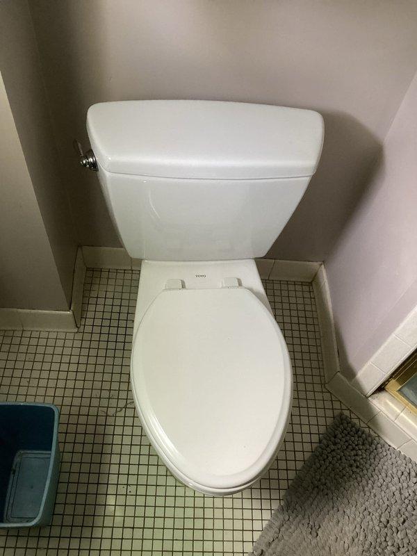 Responded to master bathroom toilet with continuous running condition and broken flush handle. Upon inspection, removed tank lid and identified worn flapper assembly and failed flush lever mechanism. Tank water showed significant mineral deposits and discoloration indicating age and hard water conditions. Replaced defective flush valve assembly including flapper seal and overflow tube. Installed new chrome flush handle and linkage assembly to restore proper manual operation. Adjusted fill valve and water level to manufacturer specifications. Tested flush cycle multiple times to verify proper tank refill, complete bowl evacuation, and elimination of continuous running. Confirmed all components sealed properly with no leaks detected. Toilet restored to full operational status.