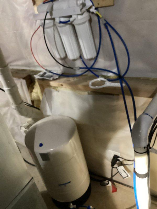 Responded to service call for odor emanating from groundwater sump pump system. Upon investigation, identified sump pump operational but discovered deteriorating water heater tank with significant rust and paint degradation in proximity to sump basin, which was contributing to moisture and odor issues in the utility area. Inspected associated plumbing connections including PVC discharge lines and verified pump cycling functionality. Documented existing water filtration system and storage tank configuration to assess potential impact on overall drainage and humidity conditions. Recommended water heater replacement due to advanced corrosion and potential failure risk, along with improved ventilation to mitigate ongoing odor concerns in the sump pump area.