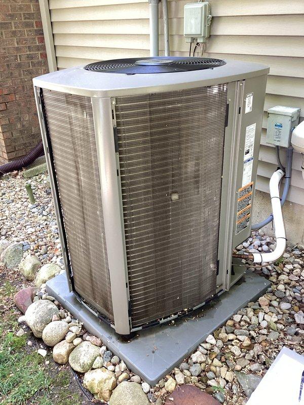 # HVAC Membership - A/C Maintenance Completed

Performed comprehensive planned maintenance service on residential air conditioning system. Conducted thorough inspection of outdoor condenser unit, including examination of electrical components, control boards, and wiring connections. Accessed internal control panel to verify proper operation of electronic controls and circuit boards. Inspected copper inductive coils, capacitors, and integrated circuits for signs of wear or damage. Verified all wire connections and harnesses were secure and properly routed. Checked condenser unit mounting on concrete pad and confirmed adequate drainage around equipment. Examined refrigerant line connections, electrical disconnect box, and PVC conduit installations. Documented equipment condition through photographic records. All components found operating within normal parameters. Unit ready for continued service.
