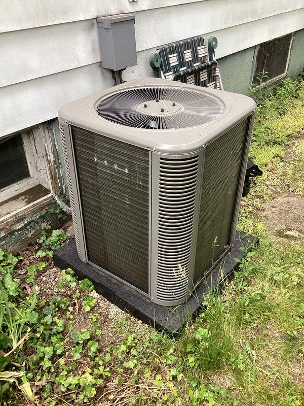 Completed scheduled air conditioning maintenance as part of HVAC membership plan. Performed comprehensive inspection of outdoor condenser unit, including examination of electrical components, contactor, and capacitor. Verified proper wire connections and electrical panel integrity. Inspected condenser coils through protective grilles and assessed overall unit condition. Documented equipment status with photographs showing exterior condenser unit on concrete pad and internal electrical components within service panel. Unit operational at time of service completion.