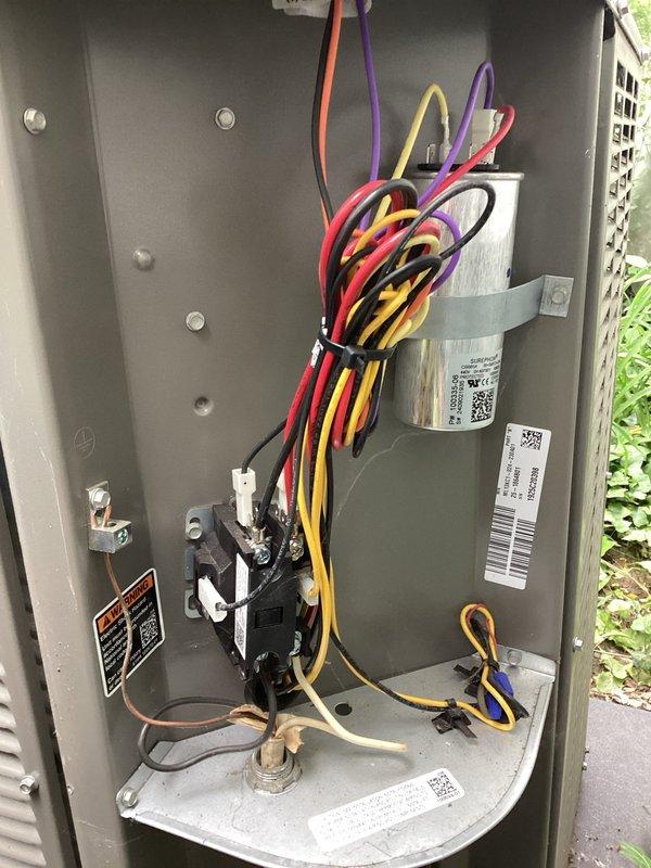 Completed scheduled air conditioning maintenance as part of HVAC membership plan. Performed comprehensive inspection of outdoor condenser unit, including examination of electrical components, contactor, and capacitor. Verified proper wire connections and electrical panel integrity. Inspected condenser coils through protective grilles and assessed overall unit condition. Documented equipment status with photographs showing exterior condenser unit on concrete pad and internal electrical components within service panel. Unit operational at time of service completion.