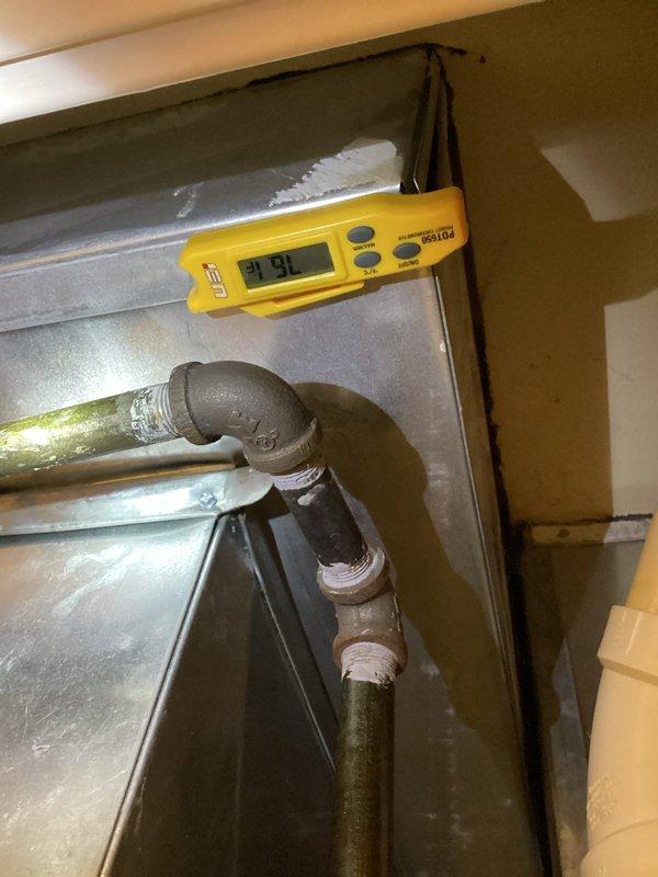 Responded to no cooling complaint in exercise room for 11-year-old system with airflow but no cooling. Upon inspection, discovered significant frost and ice accumulation on evaporator coil and air handler assembly, with coil temperature measuring 31.91°F and excessive condensation present on metal surfaces. Diagnosed restricted airflow causing evaporator coil to freeze, preventing proper heat exchange and cooling capacity. Advised customer to switch system to fan-only mode to allow ice to defrost before further diagnostic work or repairs could be performed.