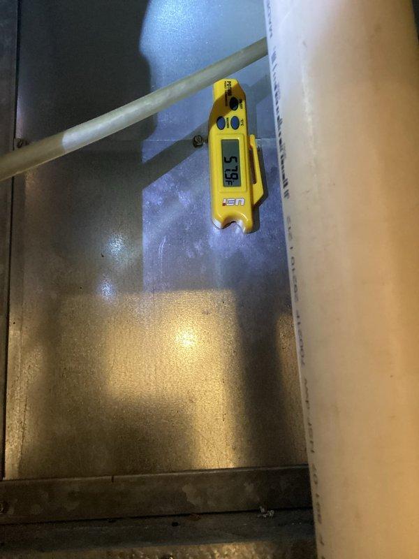 Responded to no cooling complaint in exercise room for 11-year-old system with airflow but no cooling. Upon inspection, discovered significant frost and ice accumulation on evaporator coil and air handler assembly, with coil temperature measuring 31.91°F and excessive condensation present on metal surfaces. Diagnosed restricted airflow causing evaporator coil to freeze, preventing proper heat exchange and cooling capacity. Advised customer to switch system to fan-only mode to allow ice to defrost before further diagnostic work or repairs could be performed.