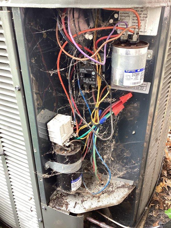 Completed planned maintenance inspection on outdoor air conditioning unit as part of recurring HVAC membership service. Accessed electrical compartment and inspected all major components including Genteq capacitor, contactor relay, wiring connections, and compressor motor. Unit interior showed significant accumulation of dirt, debris, cobwebs, and organic matter throughout compartment, indicating extended operation without recent maintenance. All electrical connections, capacitor, and contactor were visually inspected and found to be functional despite heavy soiling conditions.