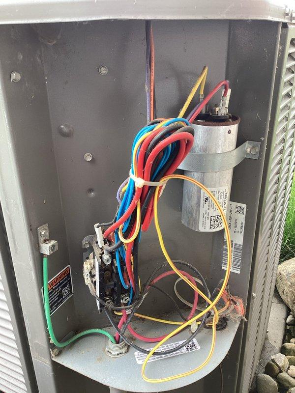 Completed planned maintenance on outdoor air conditioning unit. Upon inspection, found condenser coil heavily clogged with dirt, dust, and debris accumulation, significantly restricting airflow. Cleaned condenser coil thoroughly to restore proper heat transfer efficiency. Inspected electrical compartment components including capacitor, contactor, and wiring connections—all found in operational condition with secure connections and proper grounding. System returned to normal operating parameters following maintenance procedures.