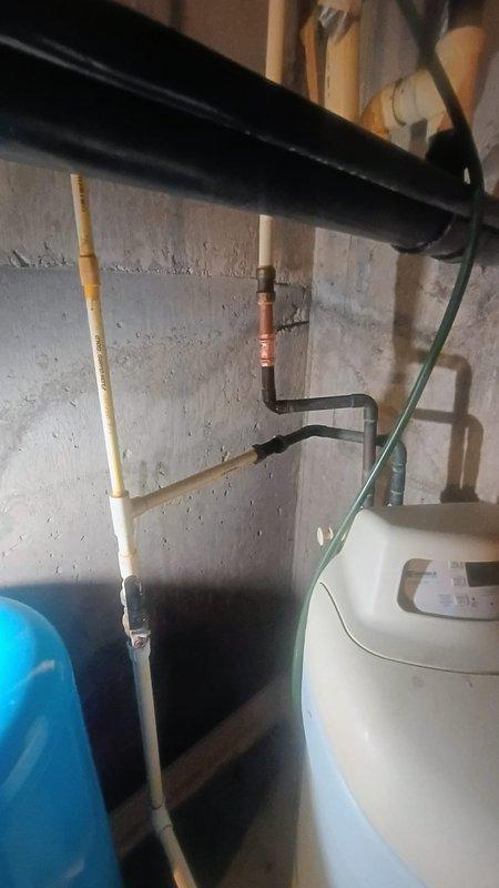 Responded to emergency call for active pipe leak in utility space. Upon arrival, confirmed water supply was shut off to prevent further property damage. Conducted thorough inspection of exposed plumbing system in basement mechanical area, identifying leak source in copper supply line near water heater installation. Assessed surrounding infrastructure including gas lines, water heaters, and associated piping for potential water damage and secondary concerns. Documented existing conditions of utility space showing exposed plumbing, dual tank water heater system, and various supply lines. Provided diagnostic evaluation and repair recommendations to address the compromised copper piping and restore safe water service to the property.