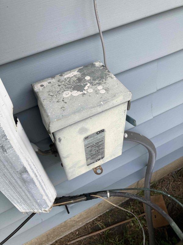Conducted comprehensive site assessment for complete HVAC system replacement at residential property. Evaluated existing 24-year-old furnace installed in 2002 and 39-year-old central air conditioning unit installed in 1987 for split system upgrade. Both units operating without current mechanical failures but have exceeded expected service life and efficiency standards.

Inspected outdoor condensing unit and associated electrical disconnect box, noting significant weathering, surface deterioration, and corrosion from prolonged environmental exposure. Documented exterior-mounted disconnect switch showing advanced age with discoloration and residue accumulation on housing. Examined indoor air handler and blower motor assembly, observing extensive rust and corrosion on motor housing, mounting hardware, and surrounding components due to moisture exposure in mechanical space. Noted deteriorated paint finish, corroded metal surfaces, and accumulated debris in equipment area indicating extende