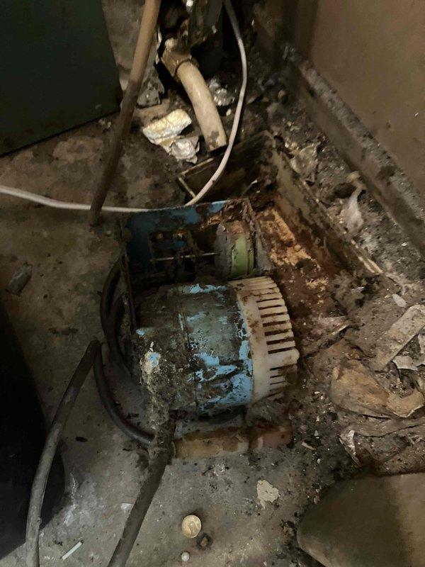 Conducted comprehensive site assessment for complete HVAC system replacement at residential property. Evaluated existing 24-year-old furnace installed in 2002 and 39-year-old central air conditioning unit installed in 1987 for split system upgrade. Both units operating without current mechanical failures but have exceeded expected service life and efficiency standards.

Inspected outdoor condensing unit and associated electrical disconnect box, noting significant weathering, surface deterioration, and corrosion from prolonged environmental exposure. Documented exterior-mounted disconnect switch showing advanced age with discoloration and residue accumulation on housing. Examined indoor air handler and blower motor assembly, observing extensive rust and corrosion on motor housing, mounting hardware, and surrounding components due to moisture exposure in mechanical space. Noted deteriorated paint finish, corroded metal surfaces, and accumulated debris in equipment area indicating extende