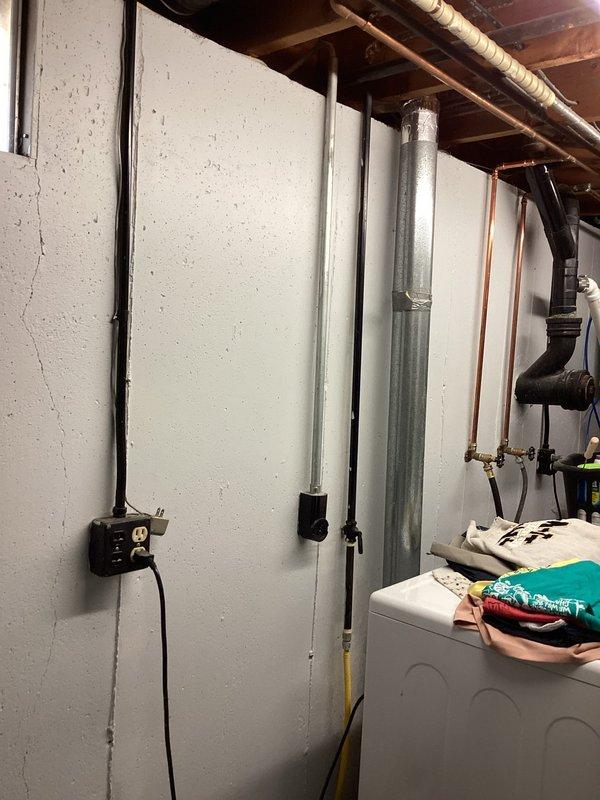Responded to service call for water heater concerns including faint gas odor, excessively hot water temperature, and leaking copper overflow pipe. Conducted thorough inspection of water heater unit and associated plumbing components in basement utility area. Performed pressure test on central heating system to evaluate system integrity and identify potential leak sources. Measured pipe dimensions using precision caliper to determine proper replacement specifications for the leaking copper temperature and pressure relief valve discharge pipe. Assessed temperature control settings and gas connection points to diagnose reported odor and overheating issues.