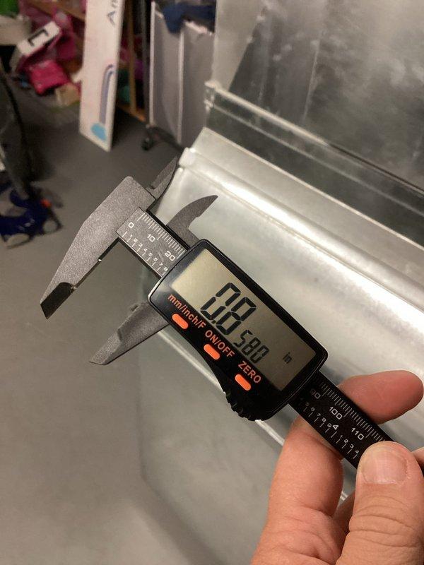 Responded to service call for water heater concerns including faint gas odor, excessively hot water temperature, and leaking copper overflow pipe. Conducted thorough inspection of water heater unit and associated plumbing components in basement utility area. Performed pressure test on central heating system to evaluate system integrity and identify potential leak sources. Measured pipe dimensions using precision caliper to determine proper replacement specifications for the leaking copper temperature and pressure relief valve discharge pipe. Assessed temperature control settings and gas connection points to diagnose reported odor and overheating issues.