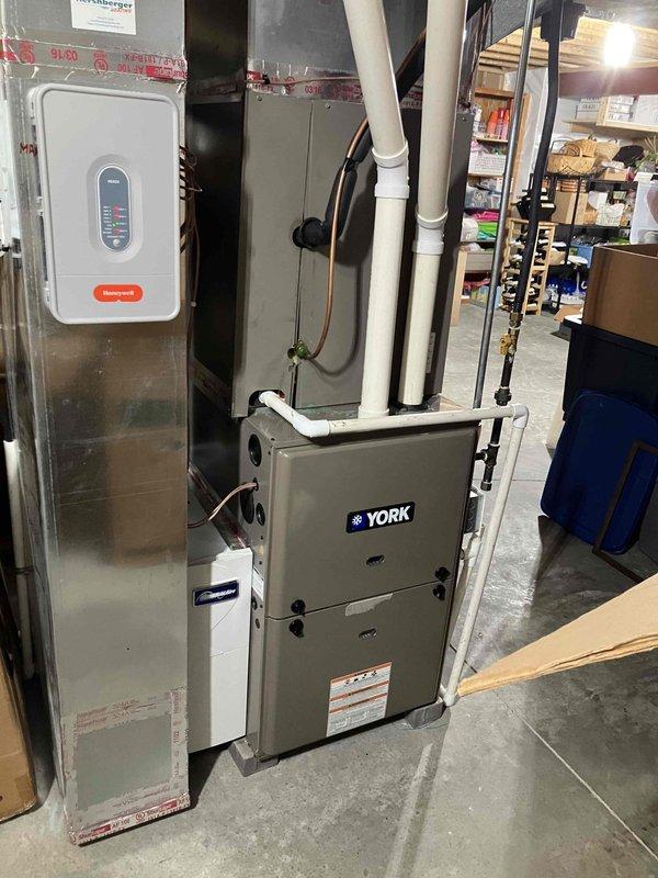 Responded to no-cooling call on York furnace system. Upon arrival, found unit completely unresponsive with no power to thermostat or equipment. Inspected electrical panel and furnace controls, identifying tripped breaker and faulty door safety switch preventing system operation. Reset breaker, replaced defective safety switch, and verified proper electrical continuity throughout system. Tested thermostat communication, confirmed furnace ignition sequence, and verified blower motor operation across all speeds. System restored to full functionality with normal heating operation confirmed.