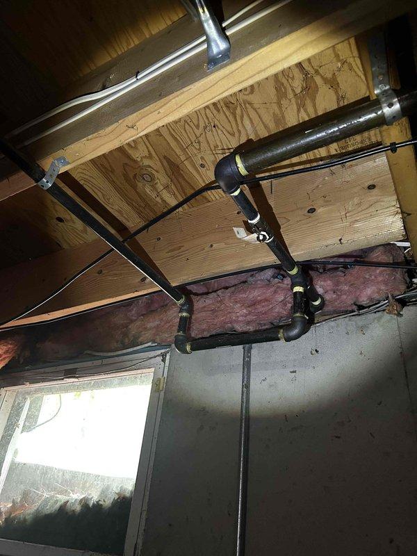 Upon arrival, diagnosed geothermal system not operating as designed due to critically low R22 refrigerant at 30 psi, causing inline low pressure switch to open. Additionally found drain line completely plugged and cleared obstruction. Per homeowner request, recharged system and added sealant to slow refrigerant leaks. After service, verified system operating with 20-degree temperature drop and 12-degree superheat. Recommended complete system replacement due to age and refrigerant loss issues. Documented existing HVAC equipment and infrastructure with photos.