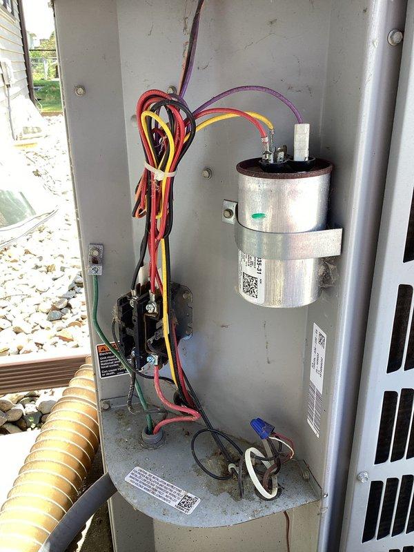 # HVAC Maintenance - Planned Single Maintenance

Completed scheduled air conditioning maintenance per membership agreement. Performed comprehensive system inspection of outdoor condensing unit, verifying proper operation of compressor, condenser fan motor, and electrical components. Inspected capacitor condition and electrical connections, confirming all wiring terminals secure and within manufacturer specifications. Evaluated condenser coil fins for damage and airflow restriction—unit showed good condition with clean, intact fins allowing proper heat transfer. Checked refrigerant lines, electrical disconnect, and mounting stability on concrete pad. Documented system condition with interior compartment and exterior unit photos showing capacitor, relay components, wiring connections, and overall equipment status. Unit operating normally with no deficiencies noted at time of service.
