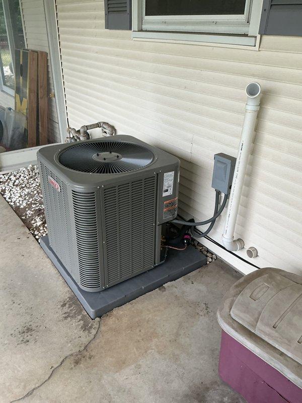 Completed full HVAC system installation including Lennox EL297UH070 high-efficiency furnace, ML17KC2-036 air conditioning unit, CK40CT-36B evaporator coil, 1410 filter cabinet, and S200 programmable thermostat. Installed furnace in basement utility area with proper PVC venting routed through overhead structure, connected refrigerant lines and condensate drainage using black flexible tubing, and completed all gas piping connections with brass fittings and shutoff valves. Mounted outdoor condensing unit on concrete pad against exterior wall with proper clearances, ran refrigerant linesets and electrical conduit through exterior wall penetration, installed white PVC condensate drain line along siding, and verified secure mounting of electrical disconnect box. Connected evaporator coil to furnace plenum, integrated filter cabinet into return air system, and completed all ductwork transitions to existing distribution system. Wired and programmed S200 thermostat for system operation, perform