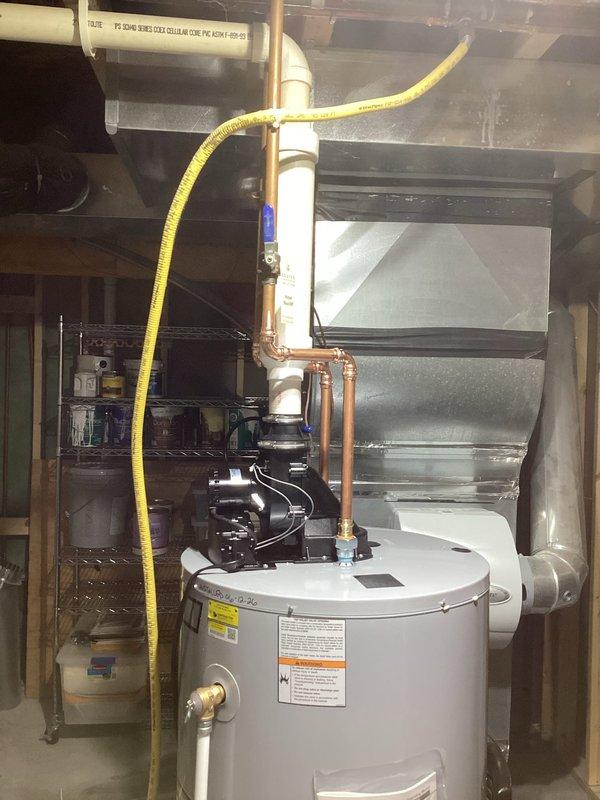 Completed installation of A.O. Smith GPVL-50 200 power vent automatic storage water heater (40,000 BTU input, 43-gallon recovery capacity) in basement utility room. Connected copper supply piping with circulator pump, installed yellow flexible gas line to unit, and verified proper venting configuration. All connections tested and operational per manufacturer specifications.