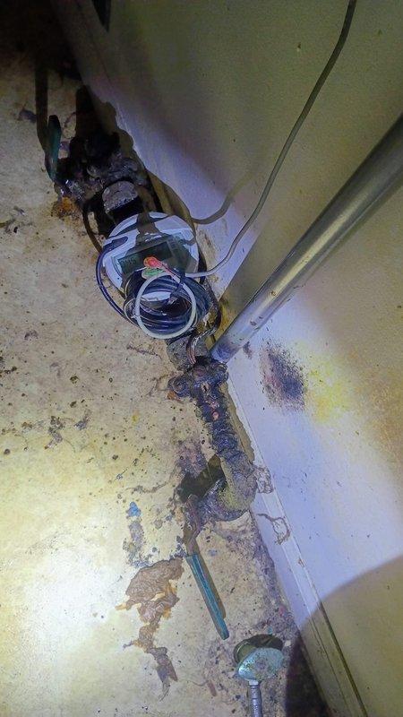 # Plumbing Service - Broken/Burst Pipes - CH

Responded to emergency service call for actively leaking copper pipe causing property damage in utility room. Upon arrival, confirmed water supply had been shut off by customer to prevent further damage. Conducted thorough assessment of affected area, revealing severely corroded copper piping with heavy oxidation and deterioration at joints and connections. The corrosion presented as dark greenish-black buildup with significant decomposition of pipe material, indicating long-term exposure to moisture and aging infrastructure. 

Documented extensive property damage including water staining on walls, floor contamination, and accumulated debris throughout the utility space. Photographed corroded pipe sections, connection points, and surrounding area to provide visual record of conditions. The affected copper line showed advanced stage corrosion requiring immediate attention to prevent recurrence of leak and potential system failure. Assessed s