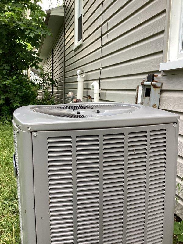 Responded to service call regarding excessive noise from outdoor condensing unit on 5-year-old residential HVAC system. Upon arrival, coordinated access with homeowner and performed visual inspection of condenser unit. Examined fan assembly, motor bearings, and compressor operation for abnormal sounds or mechanical issues. Inspected fan blades for damage, imbalance, or debris obstruction. Checked mounting hardware, grille security, and unit levelness on concrete pad. Documented unit condition with photographic evidence showing exterior housing, top-mounted fan assembly, and overall installation. System had been shut off by homeowner as precautionary measure following neighbor's report of unusual operational noise.