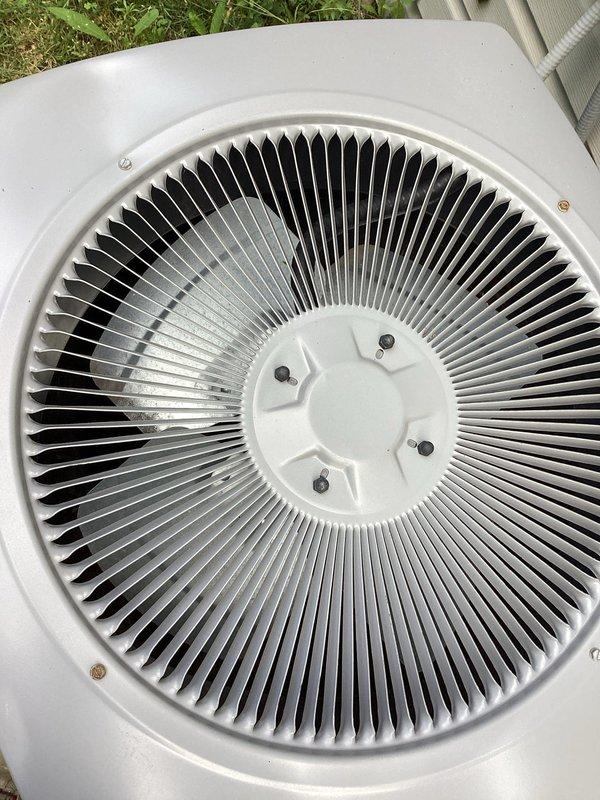 Responded to service call regarding excessive noise from outdoor condensing unit on 5-year-old residential HVAC system. Upon arrival, coordinated access with homeowner and performed visual inspection of condenser unit. Examined fan assembly, motor bearings, and compressor operation for abnormal sounds or mechanical issues. Inspected fan blades for damage, imbalance, or debris obstruction. Checked mounting hardware, grille security, and unit levelness on concrete pad. Documented unit condition with photographic evidence showing exterior housing, top-mounted fan assembly, and overall installation. System had been shut off by homeowner as precautionary measure following neighbor's report of unusual operational noise.