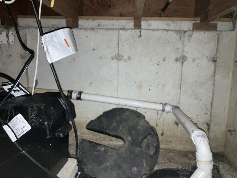 Replaced sump pump and check valve in far left corner of basement, cleaned sump pit to remove debris and sediment buildup, and installed check valve on perimeter drain discharge line. All components were properly secured with appropriate mounting hardware, electrical connections were verified, and the system was tested for proper operation and drainage flow.