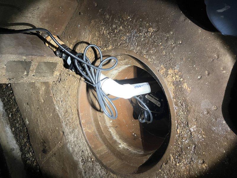Replaced sump pump and check valve in far left corner of basement, cleaned sump pit to remove debris and sediment buildup, and installed check valve on perimeter drain discharge line. All components were properly secured with appropriate mounting hardware, electrical connections were verified, and the system was tested for proper operation and drainage flow.
