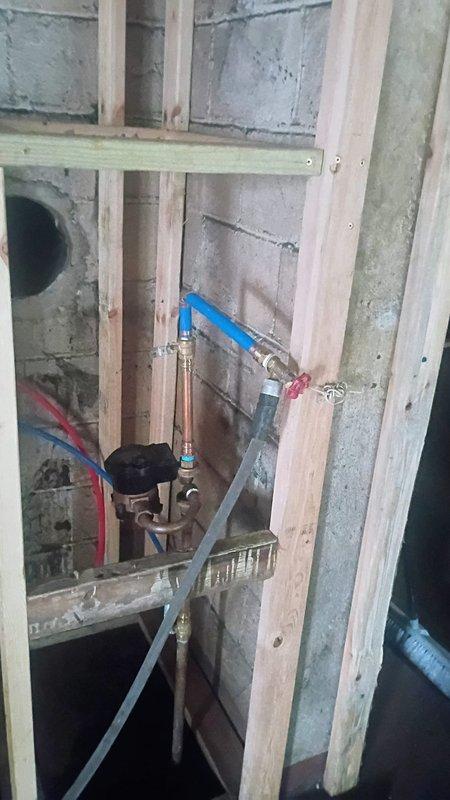 Completed installation of tanked water heater in unfinished basement area with new plumbing connections, including copper supply lines with ball valve shut-off controls and PEX tubing integration. All connections were secured to wall framing with proper mounting brackets, system tested and verified operational, with final balance collected upon completion.