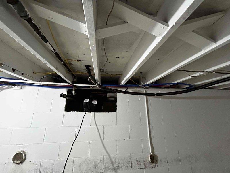 Provided estimate for temporary removal and reinstallation of existing furnace system to facilitate water damage remediation work in basement area. Documented current HVAC equipment configuration including outdoor Goodman condenser unit and basement furnace installation with associated electrical connections, refrigerant lines, and utility routing through floor joists. Quote covers disconnection of all electrical and mechanical connections, safe removal of furnace unit from work area, protection of equipment during remediation process, and complete reinstallation with reconnection of all systems upon completion of water damage repairs.