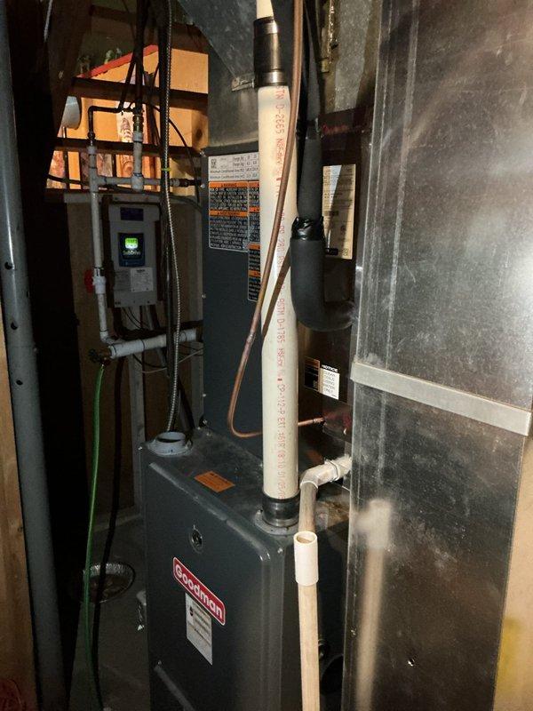 Completed full installation of Lennox ML13KC1-036 air conditioning system with CK40UT-36C air handler and T4 thermostat at residential property. Mounted air handler vertically in basement mechanical room with proper clearances and secured to structural framing. Installed refrigerant line set with copper tubing, connecting outdoor condensing unit to indoor air handler with proper insulation and routing through building envelope. Positioned outdoor condenser unit on concrete pad in backyard area with level placement and adequate clearance for airflow and service access.

Completed all electrical connections including power supply wiring, line voltage, and low voltage control wiring from main electrical panel to air handler and outdoor unit. Installed electrical disconnect box on exterior wall per code requirements for outdoor unit. Ran and terminated thermostat control wiring from air handler to T4 thermostat location. Installed PVC condensate drain line from air handler with proper pitc