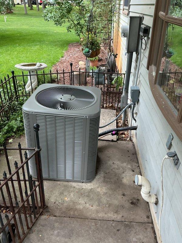 Completed full installation of Lennox ML13KC1-036 air conditioning system with CK40UT-36C air handler and T4 thermostat at residential property. Mounted air handler vertically in basement mechanical room with proper clearances and secured to structural framing. Installed refrigerant line set with copper tubing, connecting outdoor condensing unit to indoor air handler with proper insulation and routing through building envelope. Positioned outdoor condenser unit on concrete pad in backyard area with level placement and adequate clearance for airflow and service access.

Completed all electrical connections including power supply wiring, line voltage, and low voltage control wiring from main electrical panel to air handler and outdoor unit. Installed electrical disconnect box on exterior wall per code requirements for outdoor unit. Ran and terminated thermostat control wiring from air handler to T4 thermostat location. Installed PVC condensate drain line from air handler with proper pitc