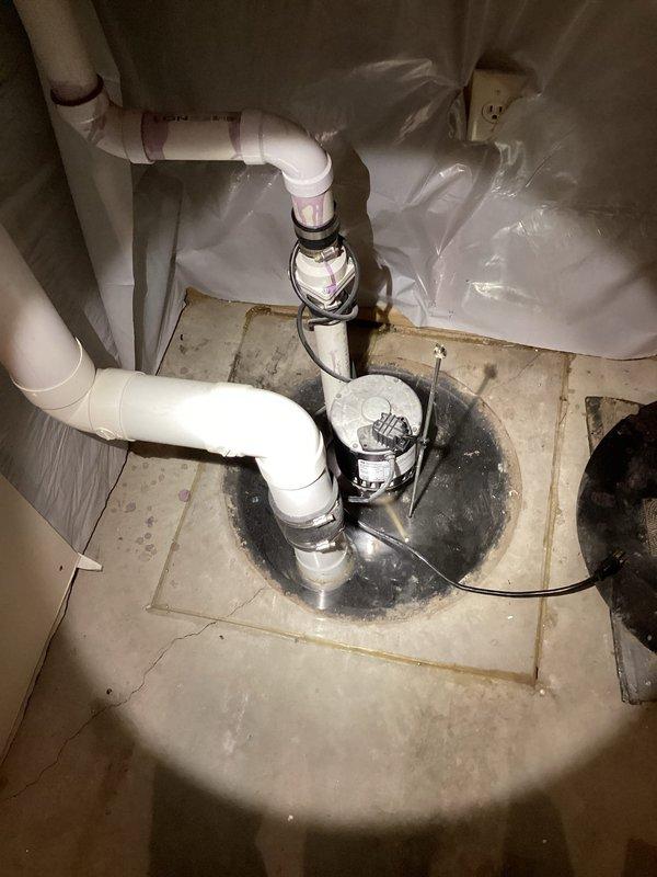 Responded to service call for non-operational radon mitigation sump pump causing water accumulation in basin. Upon arrival, confirmed pump failure with no breaker trips or electrical issues at panel. Performed diagnostic evaluation of existing Zoeller M81 pump unit and determined complete pump replacement was necessary. Removed failed pump assembly from sump basin and installed new Zoeller M81 replacement pump with appropriate electrical connections. Verified all PVC drainage piping connections were secure and properly sealed to existing radon system plumbing. Tested new pump operation through multiple cycles to ensure proper activation, discharge flow, and automatic shutoff functionality. Confirmed radon system drainage restored to normal operation with no water pooling in basin.