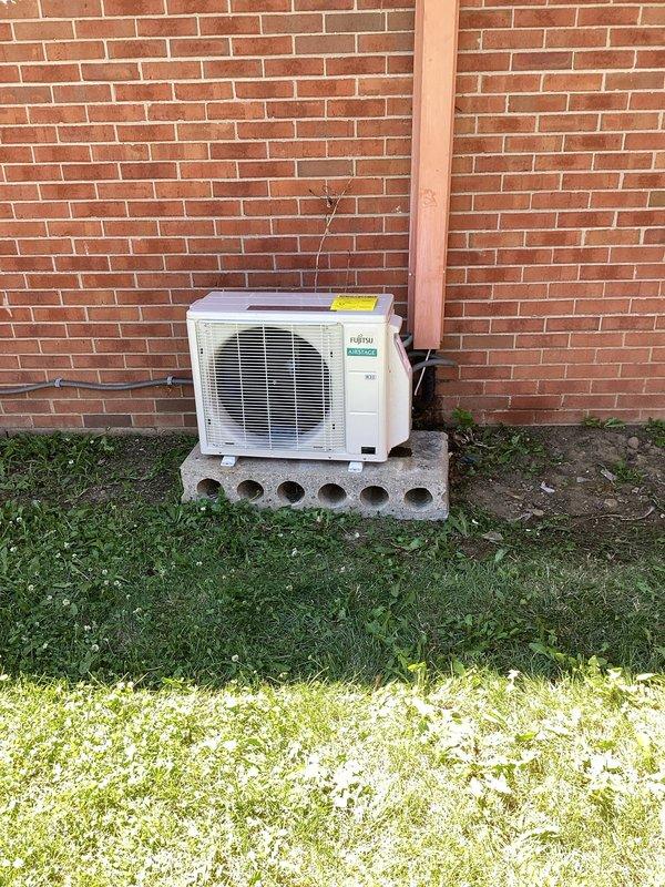 Completed full replacement of existing ductless mini-split system with new Fujitsu unit. Installed outdoor condenser on concrete masonry block platform against exterior brick wall and mounted indoor wall unit in residential space. Utilized Zoomlock press connection system with flare fittings for refrigerant lineset installation, ensuring proper connection between indoor and outdoor components. System tested and confirmed operational upon completion.