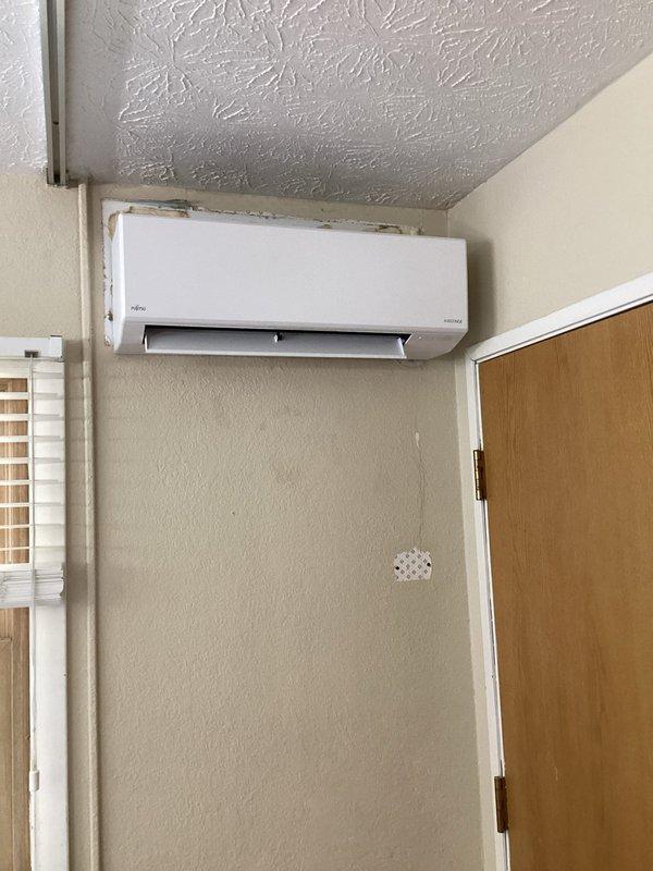Completed full replacement of existing ductless mini-split system with new Fujitsu unit. Installed outdoor condenser on concrete masonry block platform against exterior brick wall and mounted indoor wall unit in residential space. Utilized Zoomlock press connection system with flare fittings for refrigerant lineset installation, ensuring proper connection between indoor and outdoor components. System tested and confirmed operational upon completion.