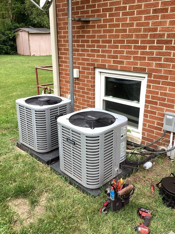Completed planned dual-system air conditioning maintenance on two residential condensing units positioned side-by-side at exterior location. Performed comprehensive preventive maintenance procedures including inspection of electrical components, capacitors, contactors, and wiring connections within control panels, cleaned condenser coils, checked refrigerant levels using manifold gauges, and replaced two 16x25x1 air filters per maintenance protocol.