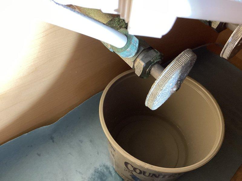 Responded to service call for leaking water supply line at bathroom sink. Upon inspection, identified corroded metal supply line connections with visible oxidation and patina buildup beneath vanity cabinet. Replaced deteriorated supply line and compression fittings, installed new flexible supply hose with proper hose clamps, and tested all connections under pressure to verify leak was eliminated and system restored to proper operation.