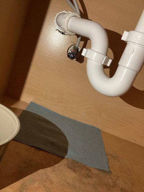 Responded to service call for leaking water supply line at bathroom sink. Upon inspection, identified corroded metal supply line connections with visible oxidation and patina buildup beneath vanity cabinet. Replaced deteriorated supply line and compression fittings, installed new flexible supply hose with proper hose clamps, and tested all connections under pressure to verify leak was eliminated and system restored to proper operation.