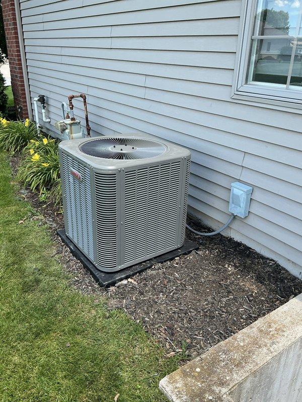 Completed full HVAC system installation including ML196UH070 furnace, ML13KC1-030 condenser unit, and CK40CT-36B evaporator coil with model 1610 and S200 components. Evacuated and recovered refrigerant from old system using recovery equipment, removed existing HVAC equipment, and installed new complete heating and cooling system. Ran new refrigerant line set from outdoor condenser to indoor air handler, properly insulated and secured copper lines to exterior wall with mounting brackets. Positioned new outdoor condensing unit on black drain pan with mulch base against home exterior, ensuring proper clearances and level installation. Connected all refrigerant lines, electrical connections, and condensate drainage. Evacuated system to proper vacuum levels, charged with manufacturer-specified refrigerant amount, and verified proper superheat and subcooling readings. Tested system operation in both heating and cooling modes, confirmed proper airflow, temperature differential, and thermostat