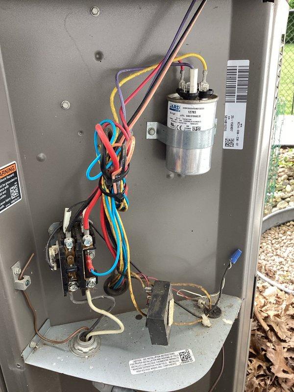 Completed comprehensive tune-up on 11-year-old outdoor air conditioning unit. Performed full system inspection including electrical panel components, capacitor testing, contactor relay examination, and verification of all wire connections. Cleaned condenser coils, checked refrigerant levels, tested fan motor operation, and confirmed proper airflow through protective grille panels. All components found operating within normal parameters with no deficiencies noted. Unit left in good working condition.