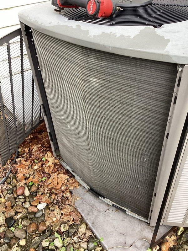 Completed comprehensive tune-up on 11-year-old outdoor air conditioning unit. Performed full system inspection including electrical panel components, capacitor testing, contactor relay examination, and verification of all wire connections. Cleaned condenser coils, checked refrigerant levels, tested fan motor operation, and confirmed proper airflow through protective grille panels. All components found operating within normal parameters with no deficiencies noted. Unit left in good working condition.