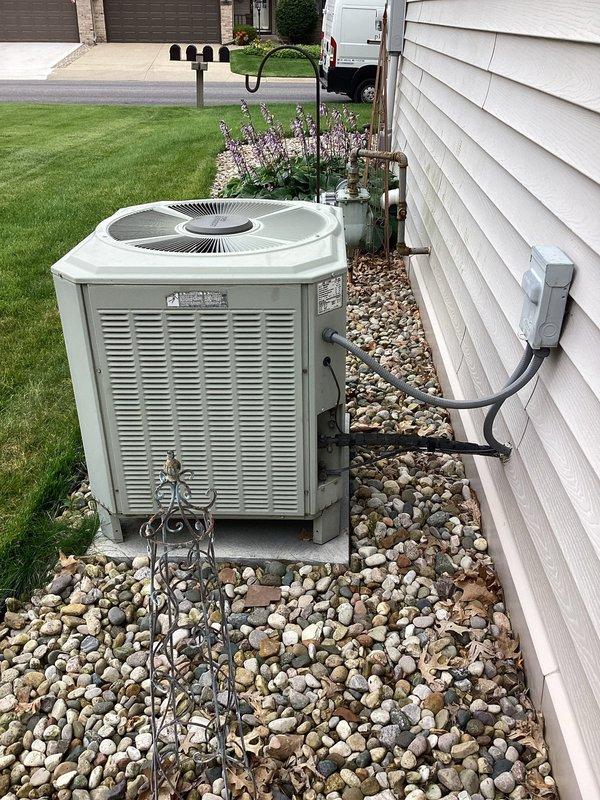 Responded to no cooling complaint on 30-year-old residential air conditioning system. Upon arrival, performed diagnostic evaluation of Trane XE 1100 model TWR036C100A1 outdoor condensing unit. Documented existing equipment condition showing significant age-related wear, oxidation on refrigerant lines, and overall system deterioration consistent with unit exceeding expected service life. Provided customer with assessment findings and replacement recommendations due to system age and obsolescence of components.