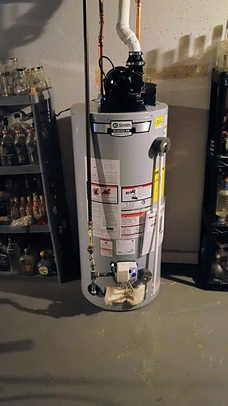 Installed a 40-gallon AO Smith tanked water heater in basement utility area per quoted specifications. Removed and cut off existing pipe that extended into the laundry room area. Completed all necessary water and gas connections, installed PVC venting system, and verified proper operation of all safety controls and valves.