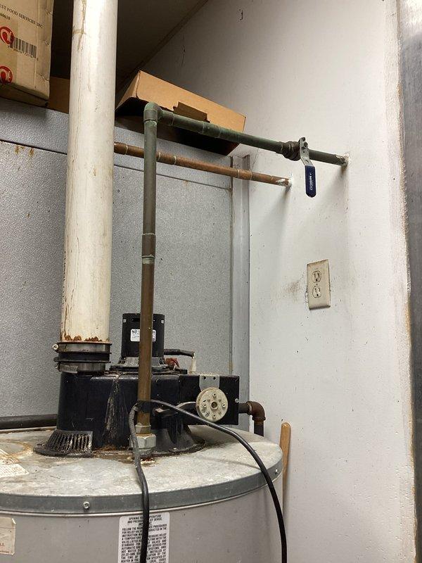 # Water Heater Ignition System Failure

Responded to service call for 15-20 year old tanked water heater with pilot light that would not remain lit. Upon arrival, confirmed unit was not producing hot water and pilot would not stay ignited. Verified gas supply was functioning properly to rule out fuel delivery issues.

Performed diagnostic inspection of the Econ-System control unit and ignition components. Testing confirmed the ignitor assembly had failed and was no longer generating spark to light the pilot. Examined the thermocouple and gas control valve for proper operation. Assessed the overall condition of the aging unit, noting significant corrosion on copper supply lines and general wear consistent with the unit's age.

Given the failed ignitor on a 15-20 year old water heater that has exceeded its typical service life, discussed repair versus replacement options. Explained that while the ignitor could be replaced, the unit's advanced age and visible deterioration of associated p