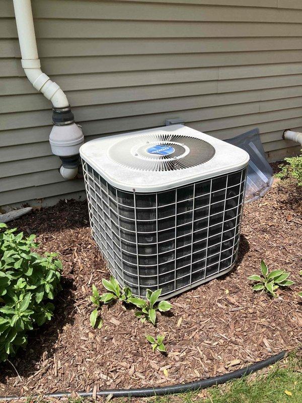 Conducted comprehensive assessment of 29-year-old residential air conditioning system experiencing water leakage at outdoor unit and inadequate cooling performance. Evaluated existing condenser unit with compromised drainage system and aging furnace/air handler assembly in basement with connected ductwork infrastructure. Prepared detailed replacement estimate comparing new equipment installation costs against continued repair expenses for aging system operating beyond expected service life.