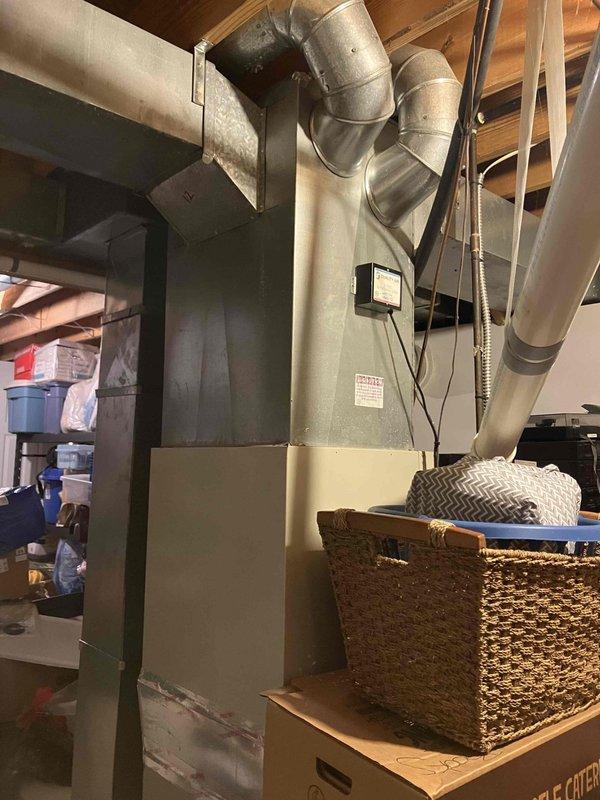 Conducted comprehensive assessment of 29-year-old residential air conditioning system experiencing water leakage at outdoor unit and inadequate cooling performance. Evaluated existing condenser unit with compromised drainage system and aging furnace/air handler assembly in basement with connected ductwork infrastructure. Prepared detailed replacement estimate comparing new equipment installation costs against continued repair expenses for aging system operating beyond expected service life.