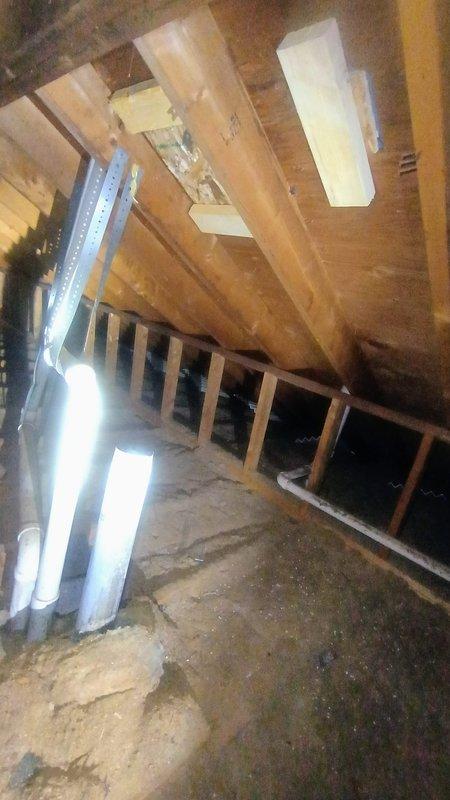 Conducted site assessment and provided estimate for water heater exhaust pipe extension in 25-year-old residential property. Inspected attic space to determine routing requirements for extending existing exhaust vent pipe 4-5 feet through attic and roof structure. Previous exhaust pipe section had been removed during recent roof replacement work. Documented attic conditions including exposed wooden joists, insulation, and roof framing to plan proper venting pathway and penetration point through roof decking. Customer will supply all necessary materials for exhaust pipe extension and cap installation.