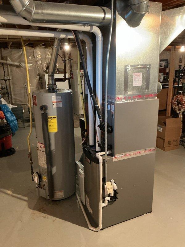 Completed full HVAC system installation in basement mechanical room including Lennox EL297UF070 high-efficiency furnace, EL18KCV-036 air conditioner with CK40CT-30B-71 coil, and S40 smart thermostat. Installed Aprilaire 1610 media air cleaner and 600 humidifier with hot water connection per customer request. All ductwork connections completed, equipment tested and verified operational.