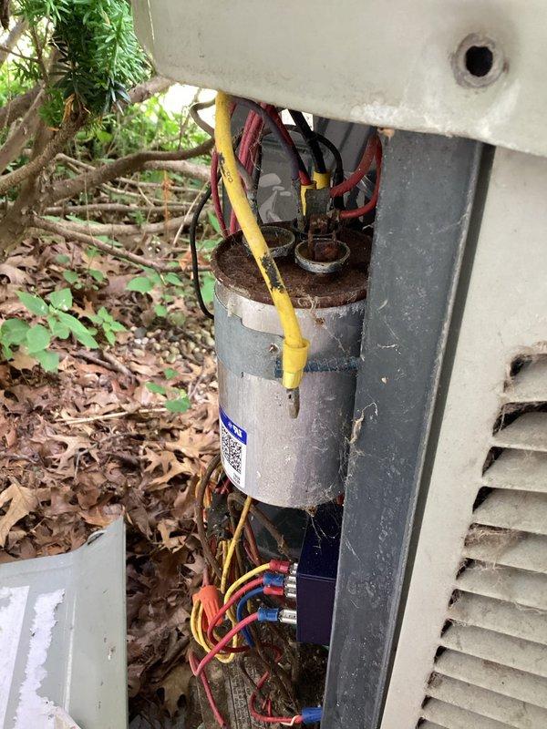 Responded to no cooling complaint with thermostat set to 70°F and indoor temperature at 83°F. Upon inspection, found failed dual run capacitor on outdoor condensing unit with visible corrosion at terminal connections and physical deterioration. Replaced defective capacitor with manufacturer-specified component, verified proper compressor and condenser fan motor operation, and confirmed system returned to normal cooling cycle with appropriate temperature differential across evaporator coil.