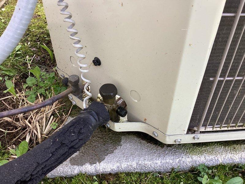 Responded to no-cooling complaint with thermostat set to 68°F but indoor temperature reading 76°F. Upon arrival, observed water accumulation around base of indoor furnace unit. Performed visual inspection of outdoor condensing unit and confirmed proper electrical connections and refrigerant line connections at service valves. No breaker trips reported, airflow present at registers, and no evidence of evaporator coil icing observed at indoor unit. Documented system conditions with exterior photographs showing outdoor unit installation and drainage area near foundation.